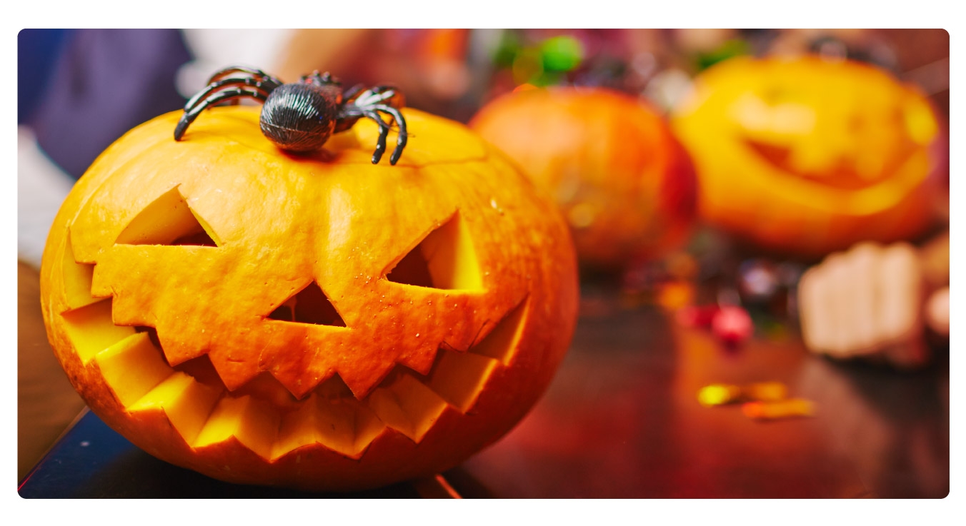 Image of people carving pumpkins as a team building activity.